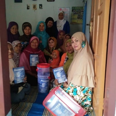 Female village entrepreneurs selling point of use water filters to last mile tile